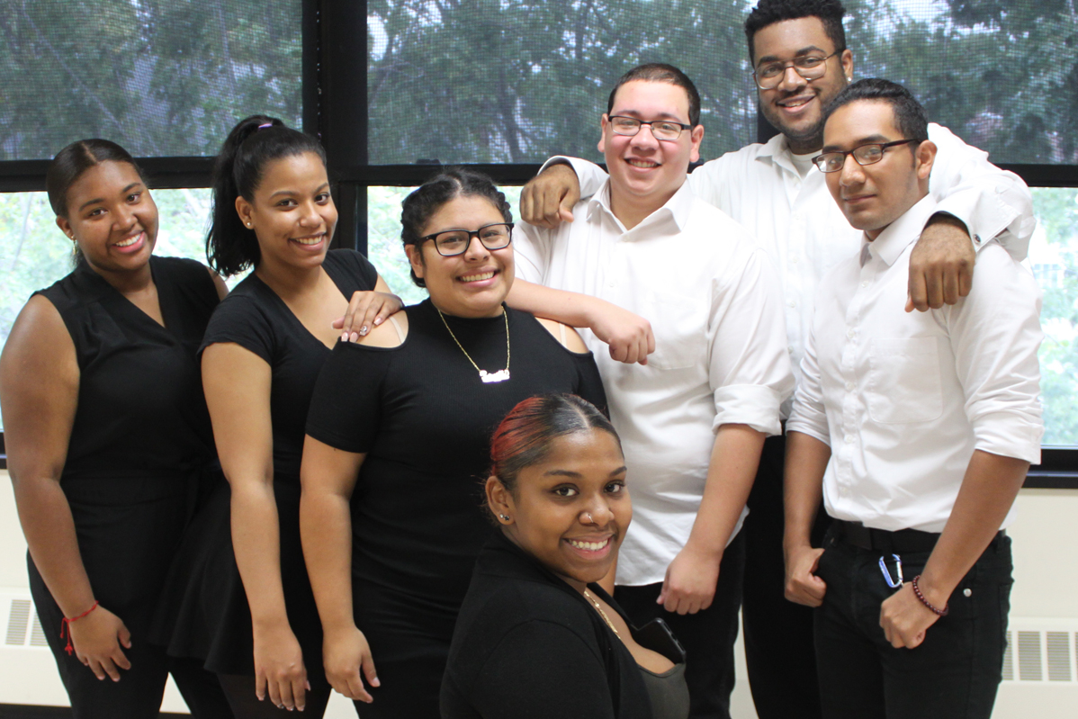 College of Westchester Just Dance Crew members posing together in coordinated black outfits before a performance